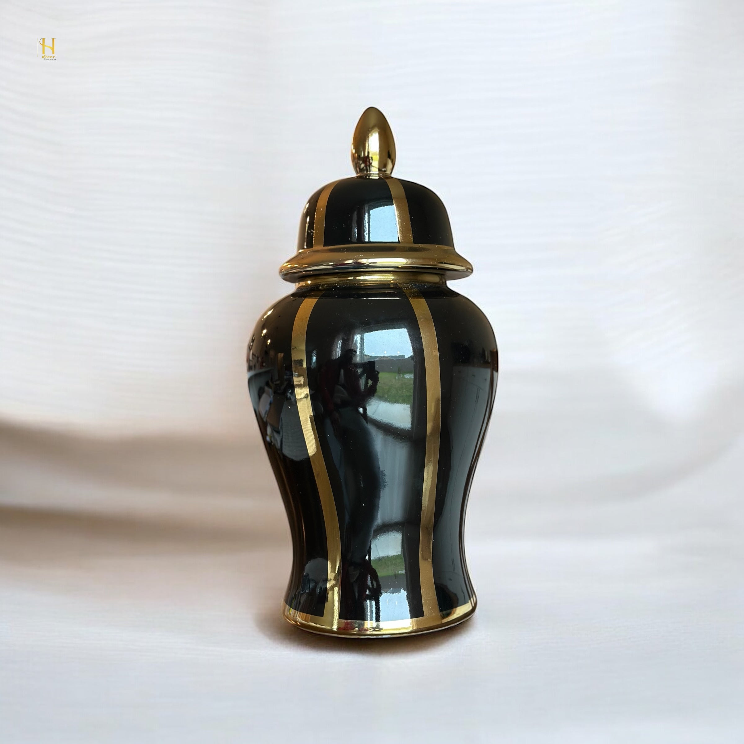Black ginger jar with golden stripes